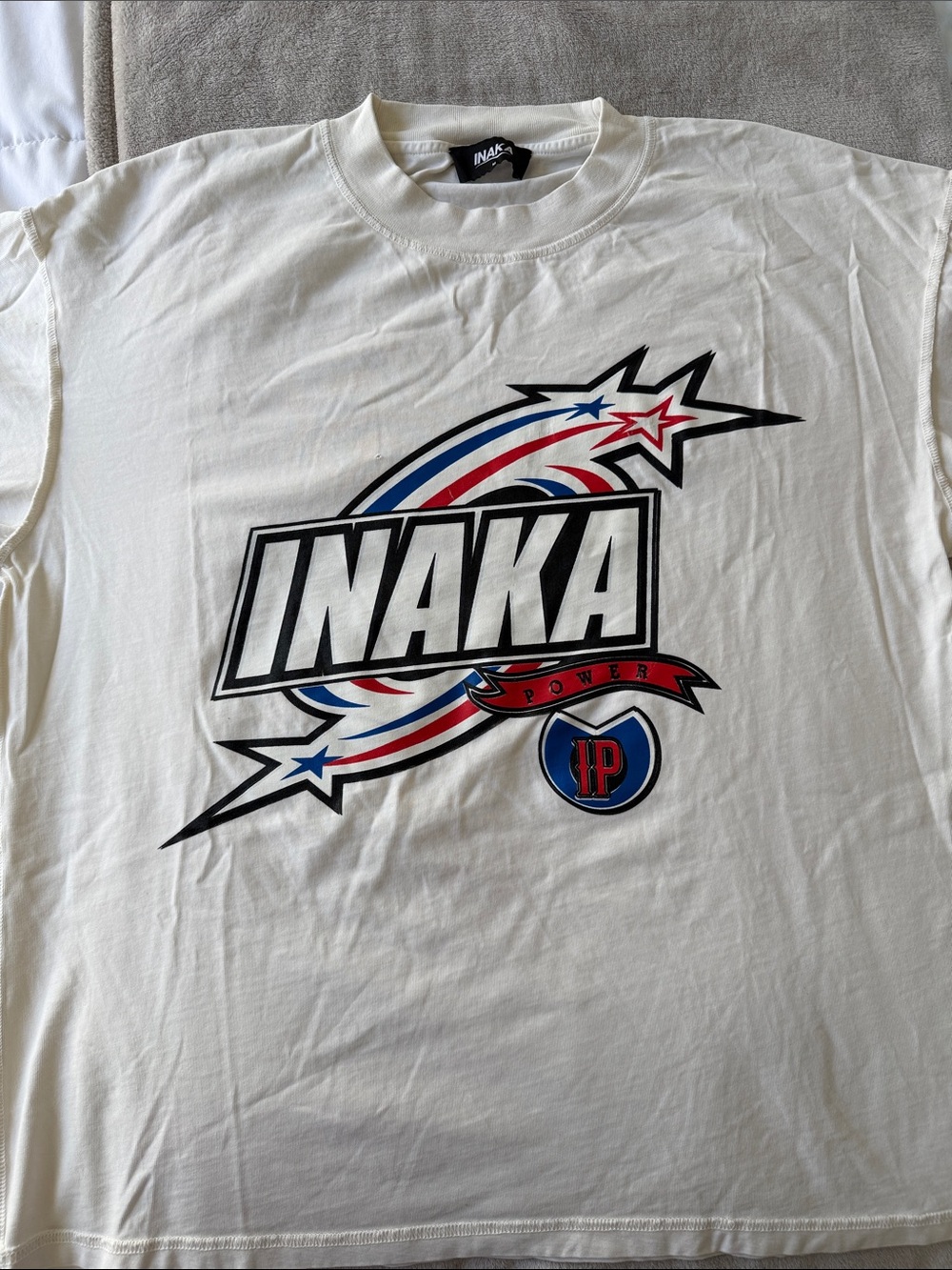 Inaka Power White Tee with Red, Blue & Black Graphic